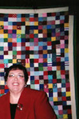 Lana Noone in front of Vietnam Babylift Quilt