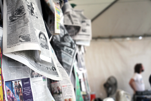 Newspapers and other publications of many different languages line the backdrop of the Talkstory stage.