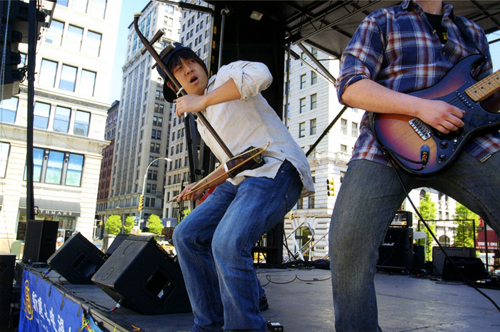 Jack Hsu, a Chinese American musician with the progressive rock band 'Hsu-Nami,' plays the electrified erhu, a Chinese two-stringed fiddle, at the 2007 Asian/Pacific American Heritage Festival in New York City. Photo Copyright Corky Lee