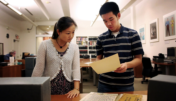 Summer 2010 intern Xiang Siow shows some findings he came across to staffer Noriko Sanefuji at the National Museum of American History's Archive Center.