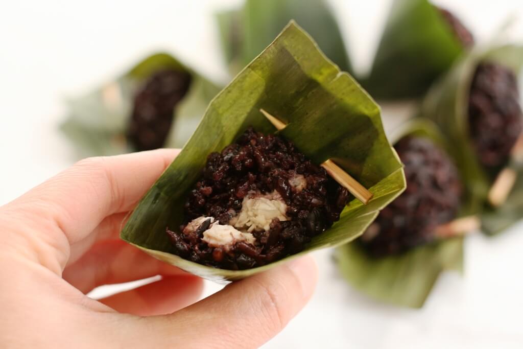 When you take a bite of this delicious dumpling, you'll be biting into a savory, spiced chicken filling wrapped with slightly sweet purple sticky rice imbued with the tealike flavor of banana leaves.