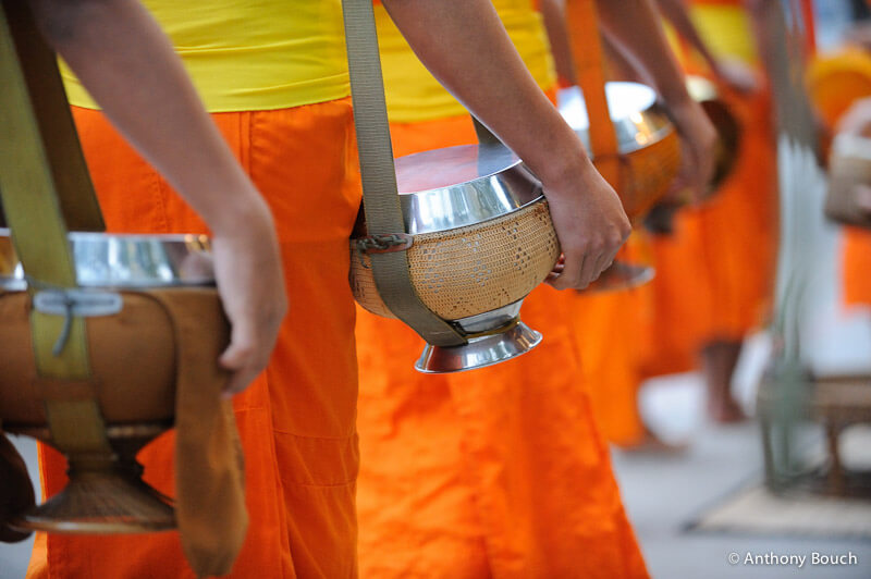 Monks receiving alms in the early morning of Luang Prabang. (Photo credit: Anthony Bouch)